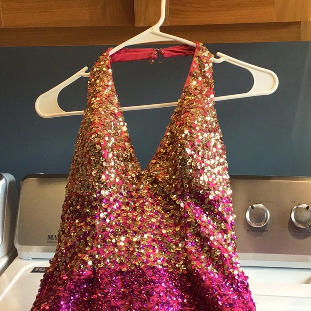 Ball / pageant gown heavily sequined bodice lightly sequined skirt. Halter back
